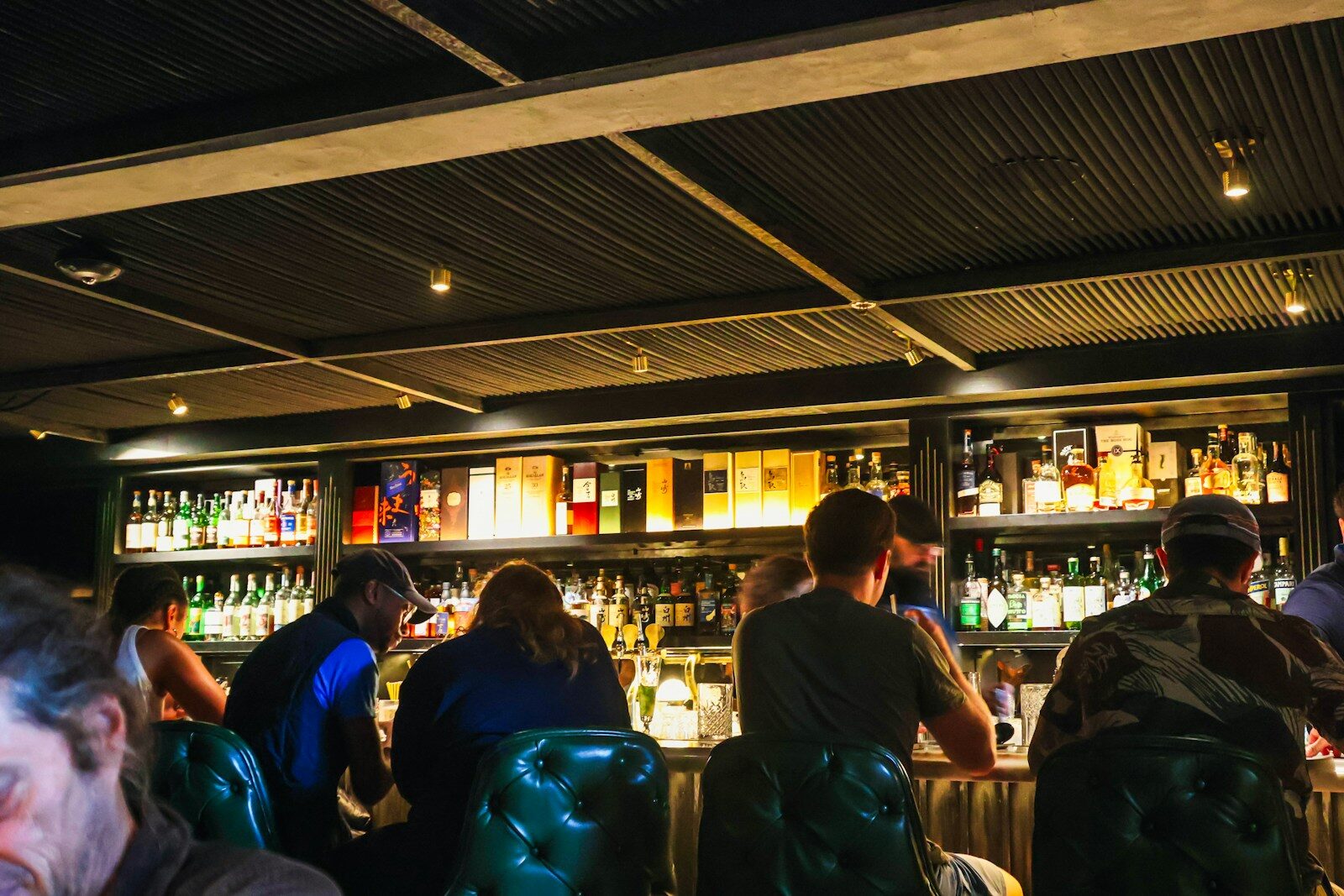 A group of people sitting at a bar
